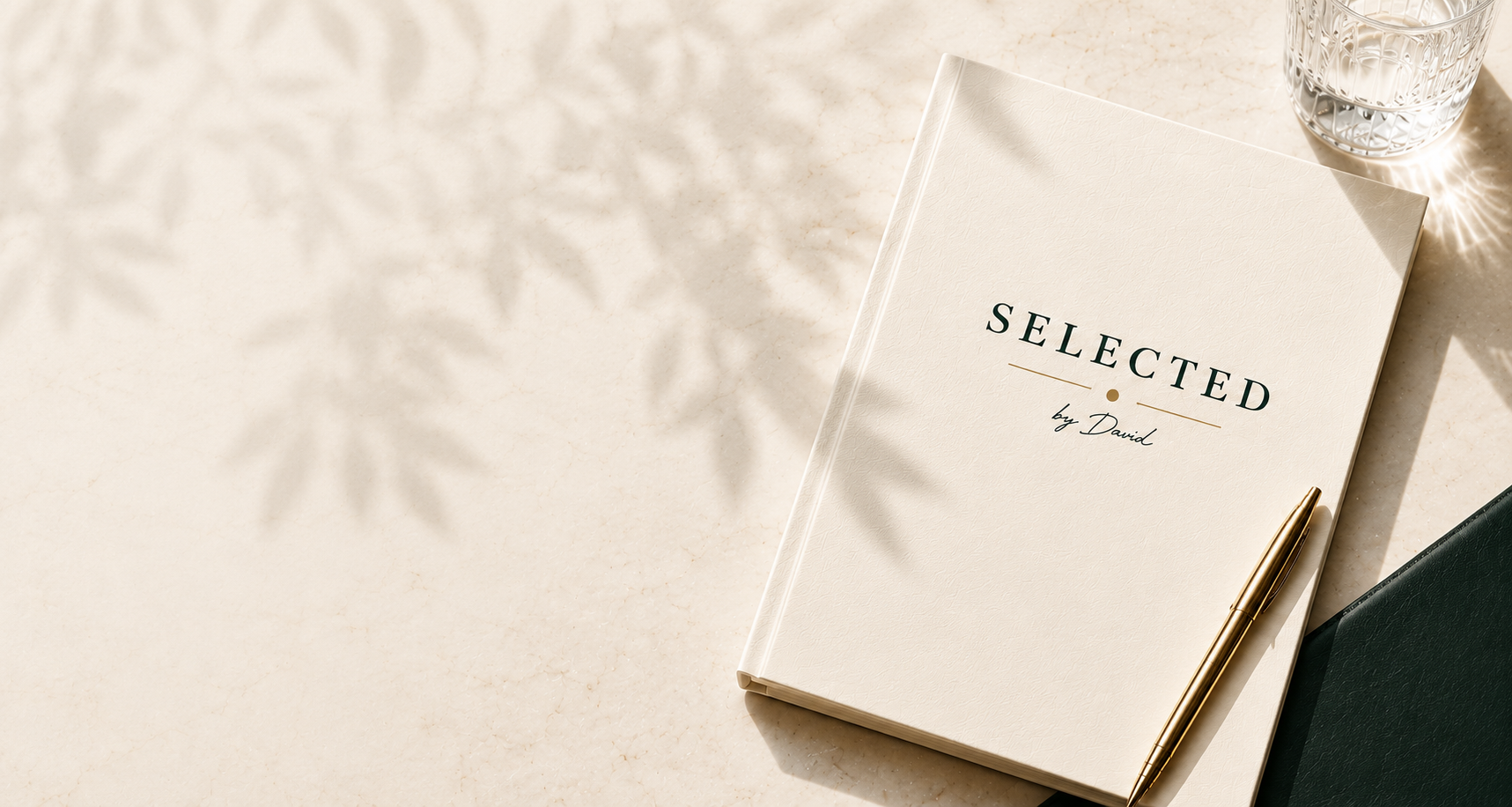 The Selected by David book resting on marble with a gold pen